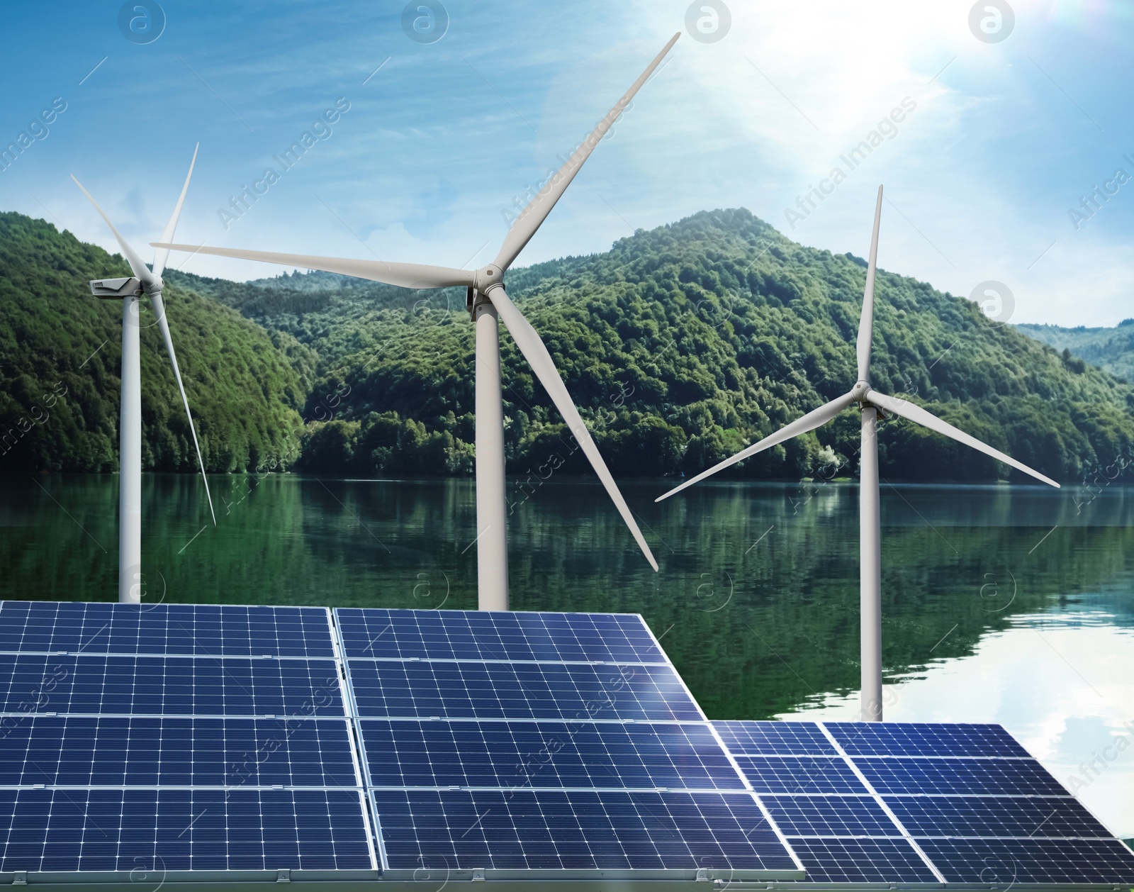 Image of Alternative energy sources. Wind turbines installed in water, solar panels on foreground