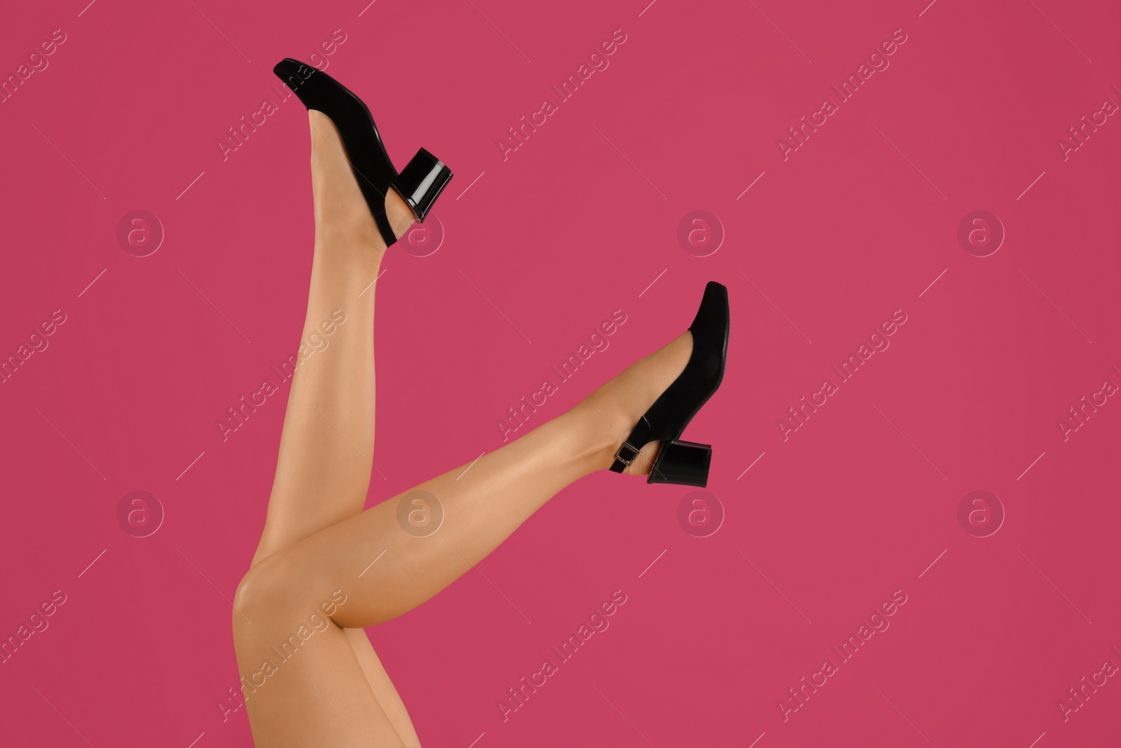 Photo of Woman wearing stylish shoes on pink background, closeup