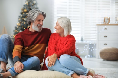 Happy mature couple celebrating Christmas at home