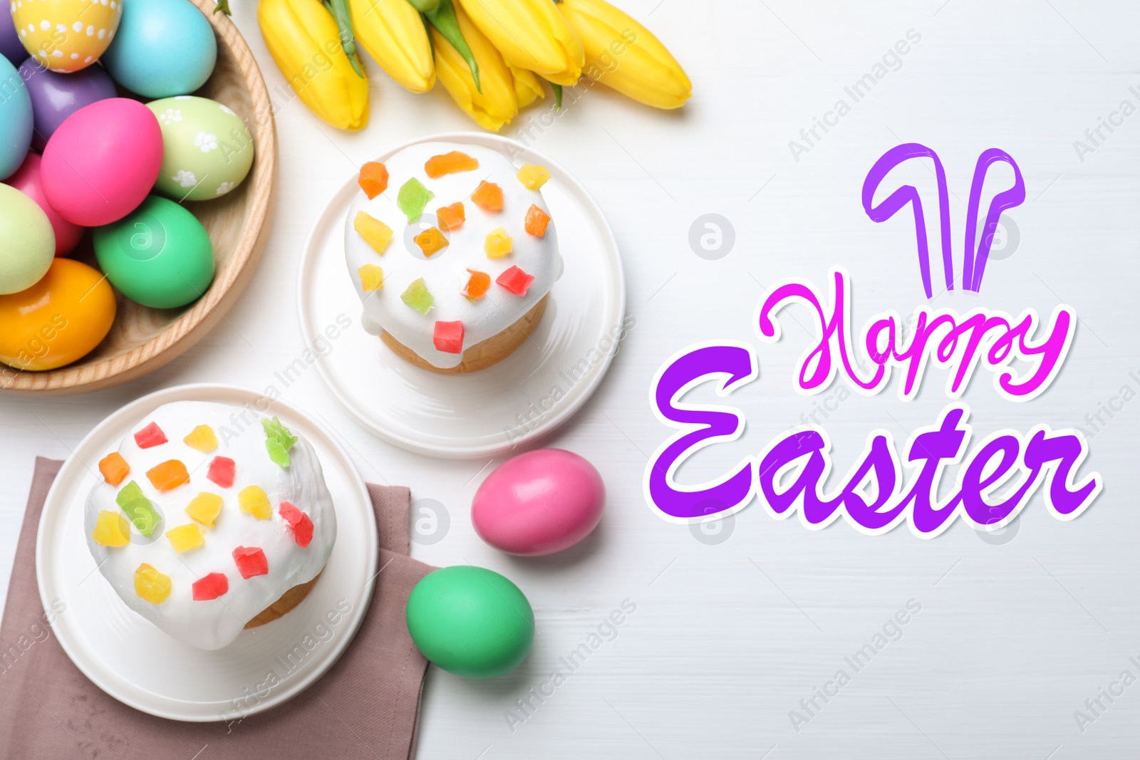 Image of Happy holiday. Easter cakes, color eggs and tulips on white wooden table, flat lay