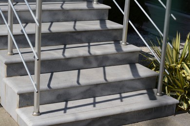 Staircase with handrails outdoors on sunny day, closeup
