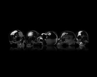 Shiny human skulls on black background. Collage design