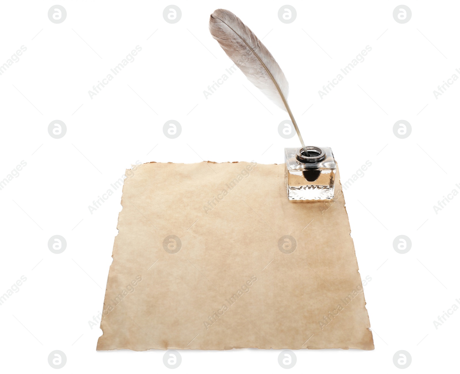 Photo of Feather pen with inkwell and blank paper on white background. Space for text