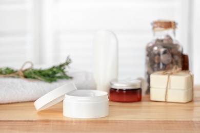 Photo of Jar with cream on wooden table. Body care cosmetics