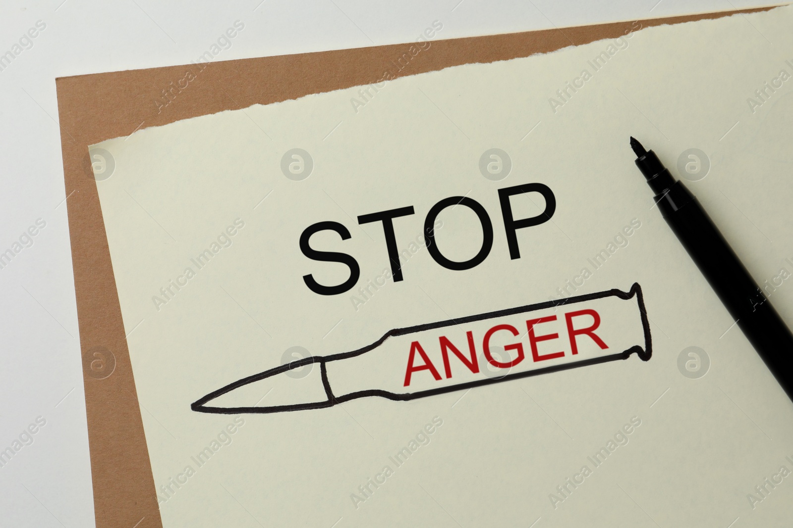 Photo of Sheet of paper with inscription Stop Anger and drawn bullet on white table, top view