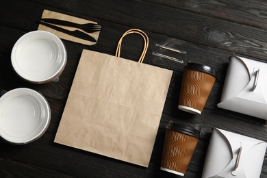 Different containers for mock up design on wooden background, top view. Food delivery service