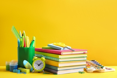 Photo of Different school stationery on yellow background