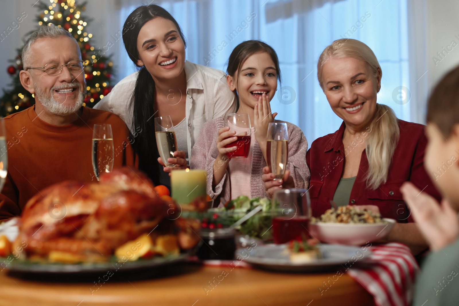 Photo of Happy family enjoying festive dinner at home. Christmas celebration