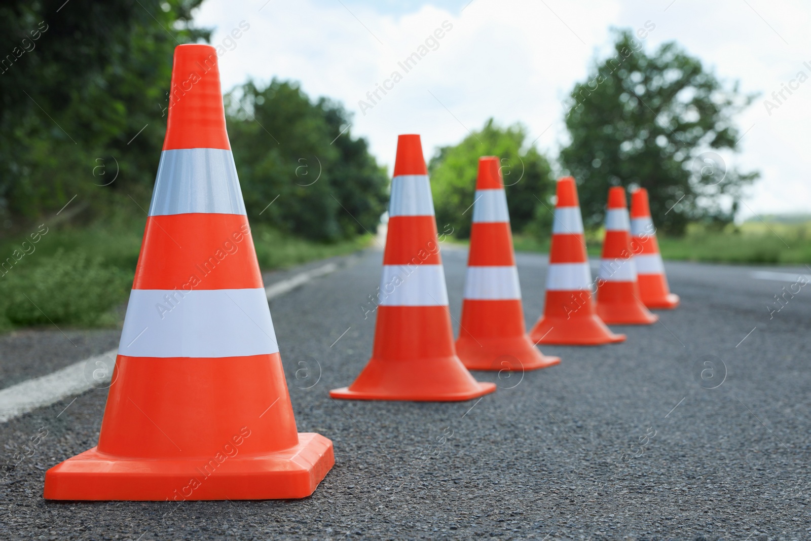 Photo of Traffic cones on asphalt highway. Road repair