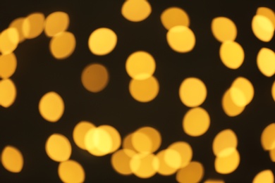 Beautiful golden lights on dark background. Bokeh effect