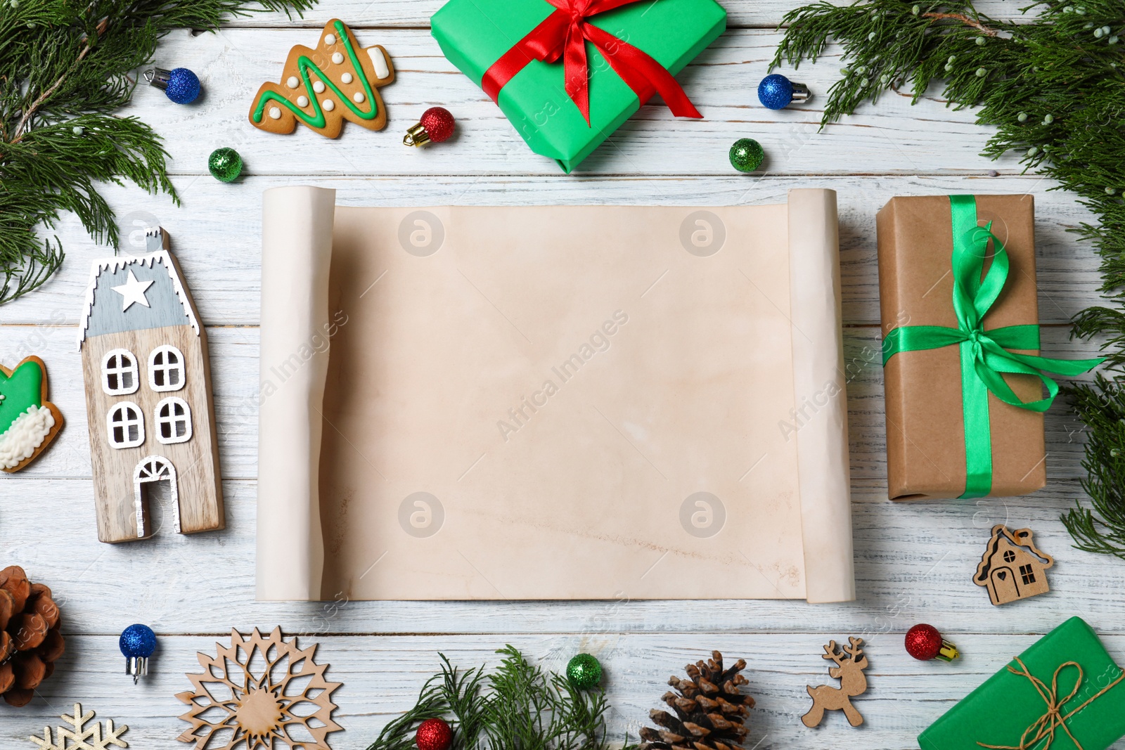 Photo of Flat lay composition with empty card and Christmas decorations on white wooden table, space for text. Writing letter to Santa Claus