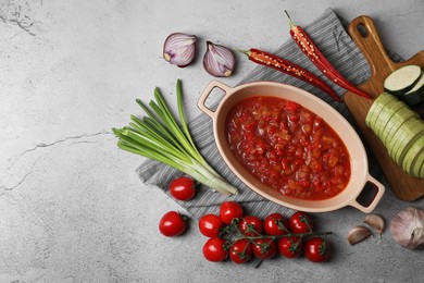 Dressing for ratatouille and different fresh vegetables on light grey table, flat lay. Space for text