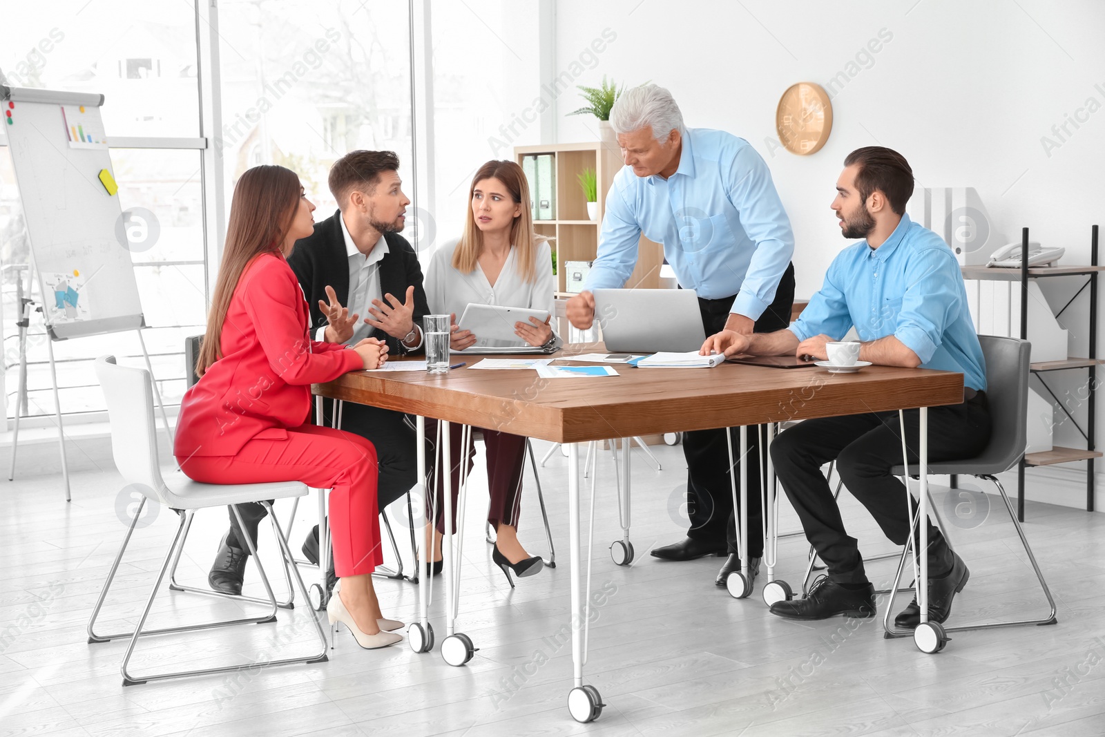 Photo of Office employees having argument during business meeting