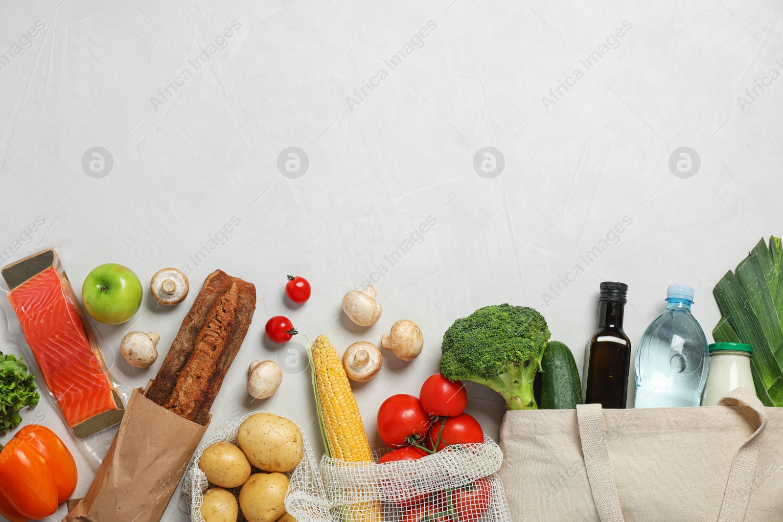 Photo of Fresh vegetables and other products on light grey background, flat lay. Space for text