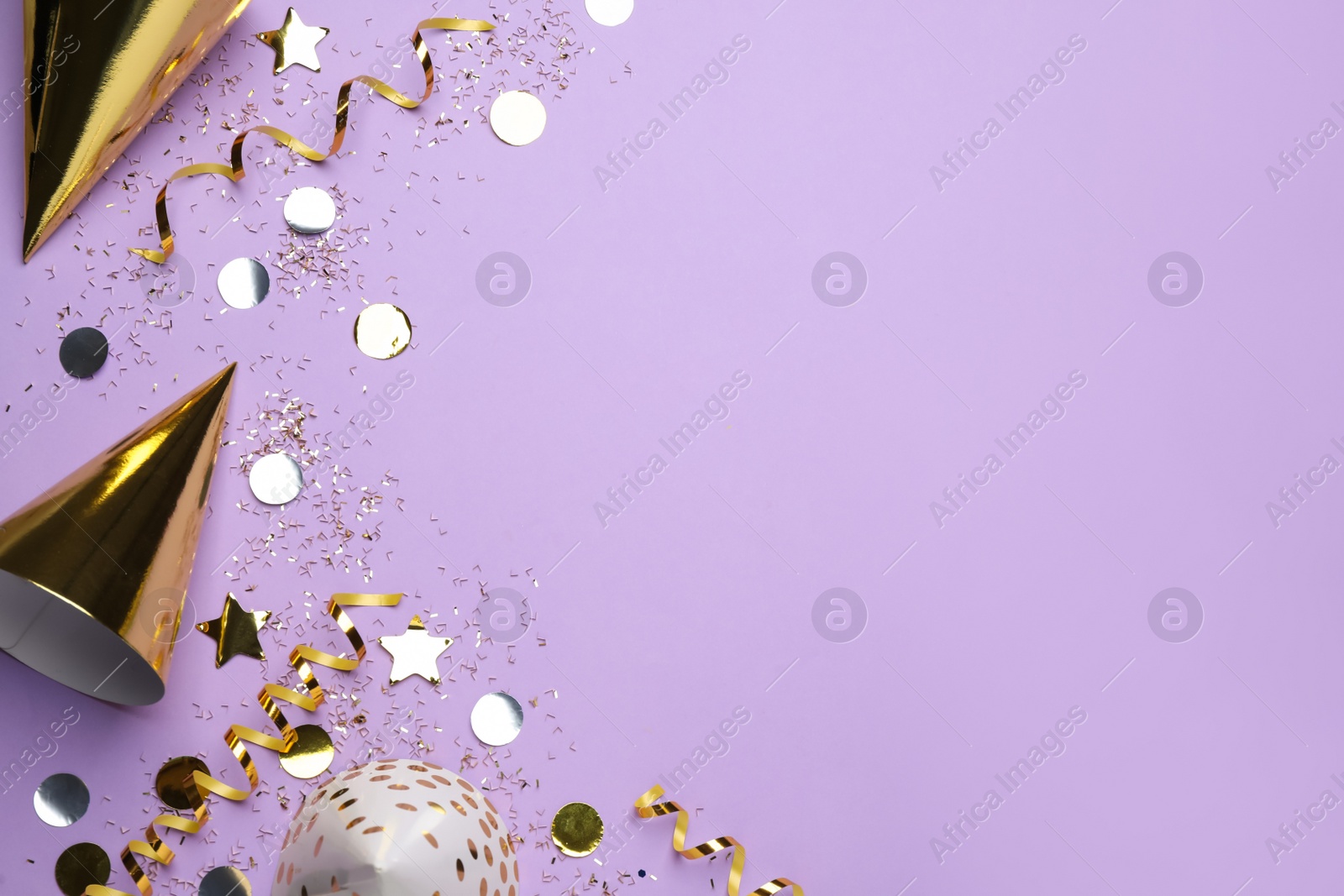 Photo of Flat lay composition with party hats and decor on pale violet background, space for text