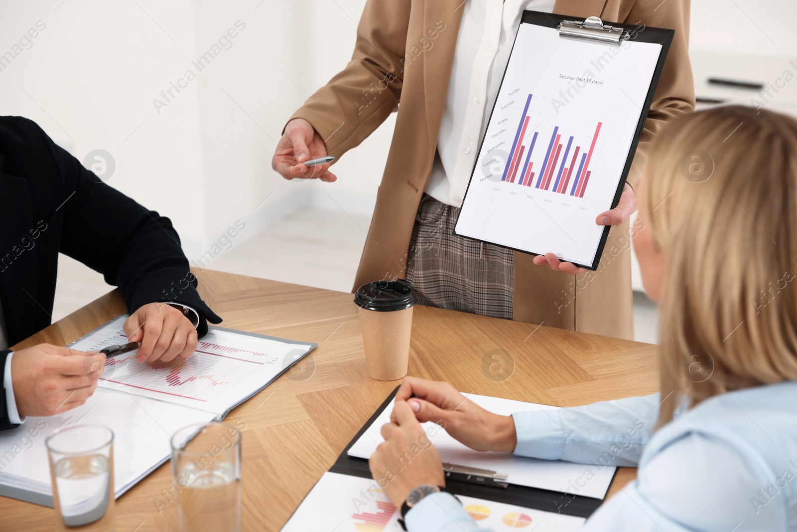 Photo of Businesswoman showing chart on meeting in office, closeup