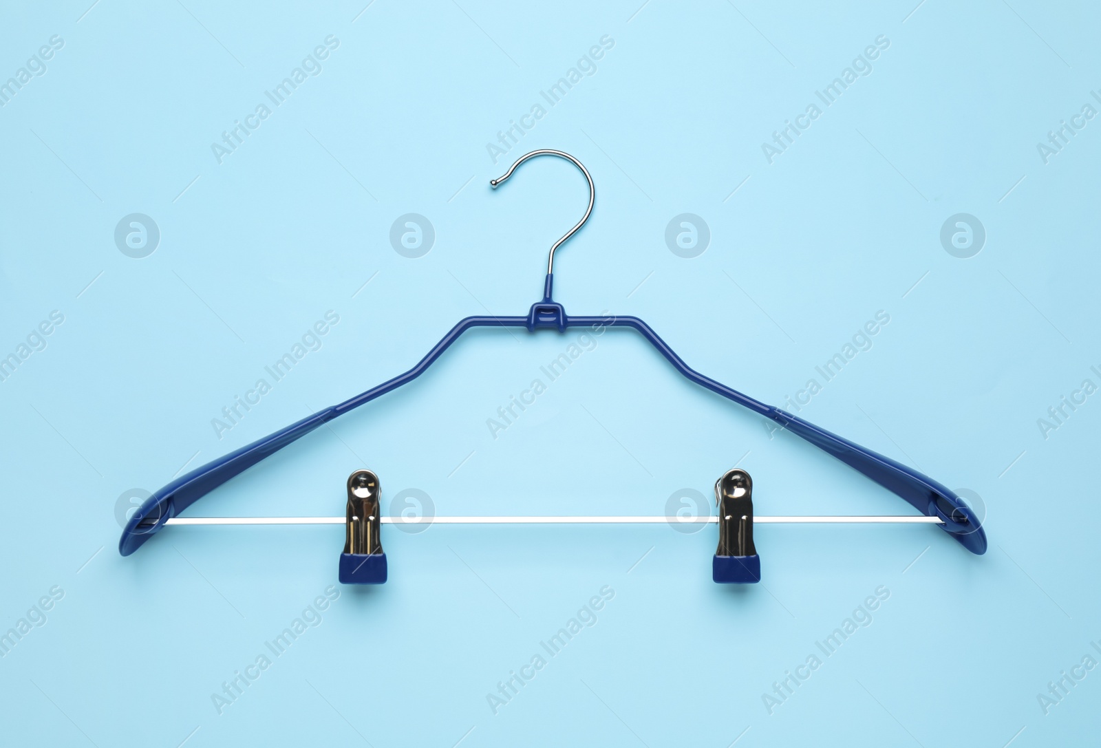 Photo of Empty hanger on light blue background, top view