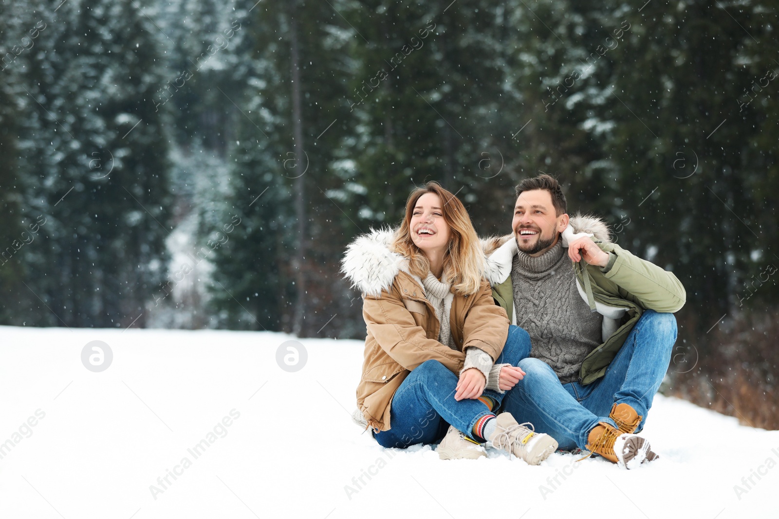 Photo of Couple spending time outdoors on snowy day, space for text. Winter vacation