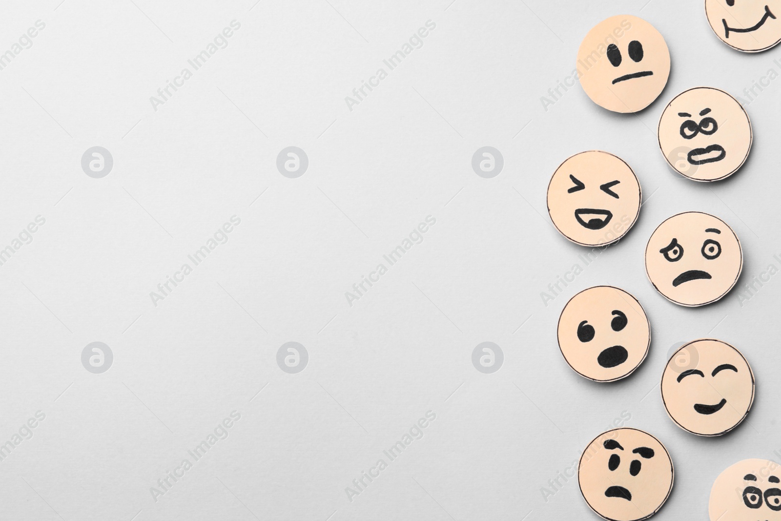 Photo of Many faces with different emotions on grey background, flat lay. Space for text