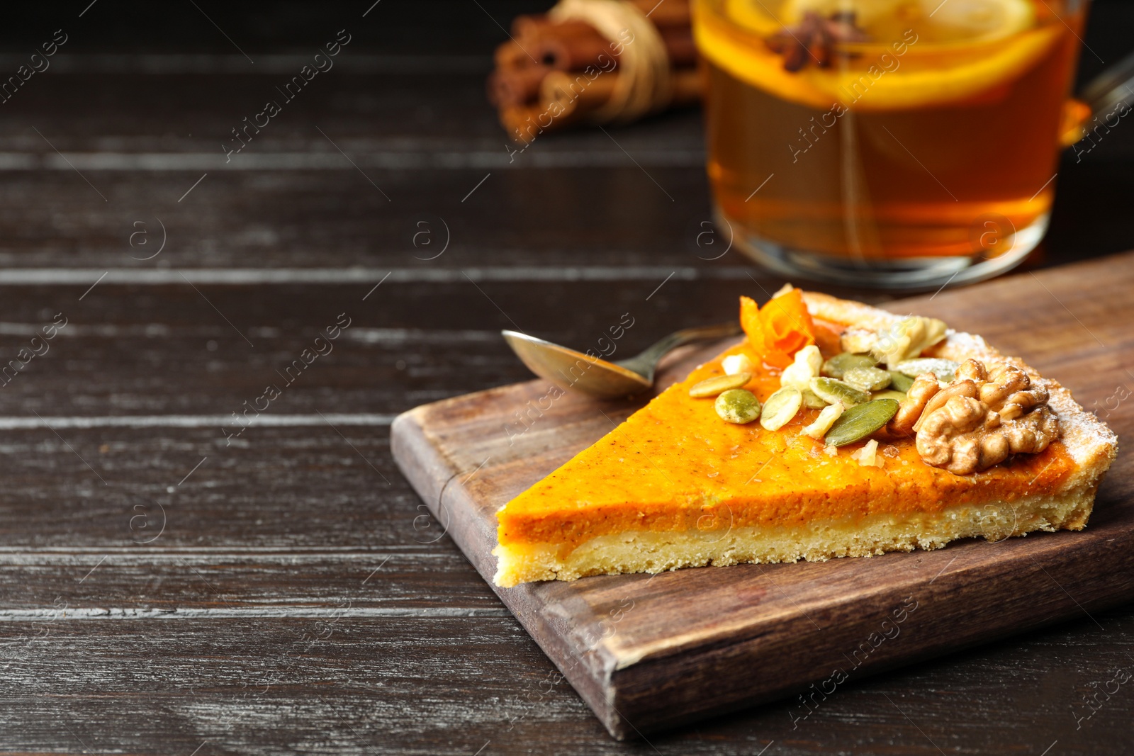 Image of Piece of fresh homemade pumpkin pie on wooden table