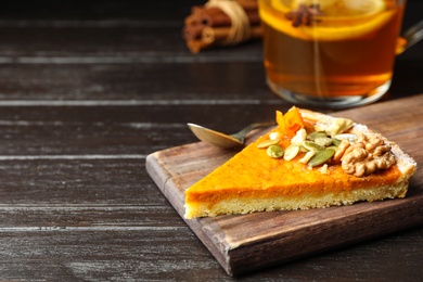 Piece of fresh homemade pumpkin pie on wooden table