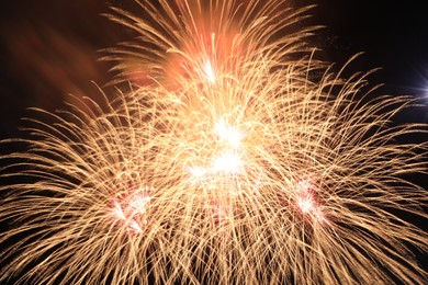 Photo of Beautiful fireworks lighting up night sky outdoors