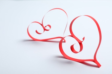 Photo of Hearts made of paper strips on white background