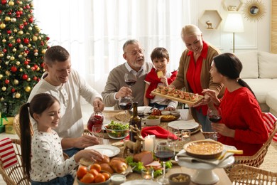 Photo of Happy family enjoying festive dinner at home. Christmas celebration