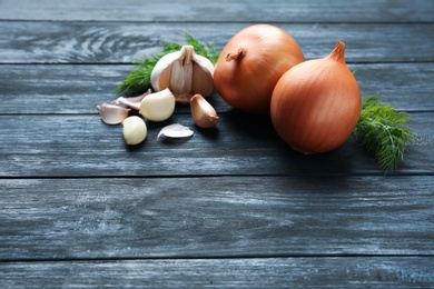 Photo of Composition with garlic and dill on wooden background. Space for text
