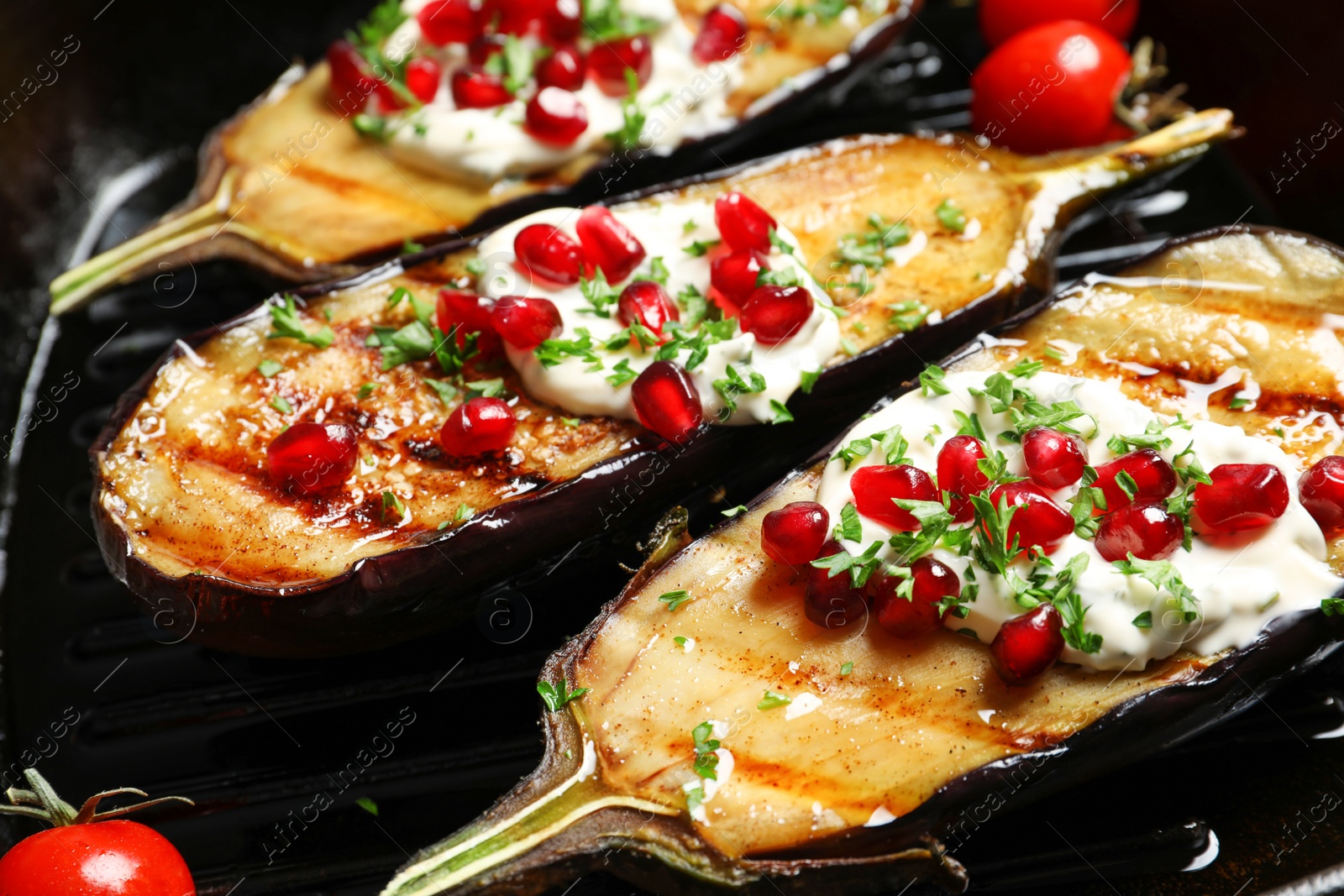 Photo of Grill pan with tasty fried eggplants, closeup