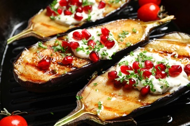 Grill pan with tasty fried eggplants, closeup