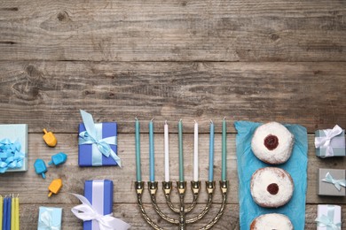 Flat lay composition with Hanukkah menorah and gift boxes on wooden table. Space for text