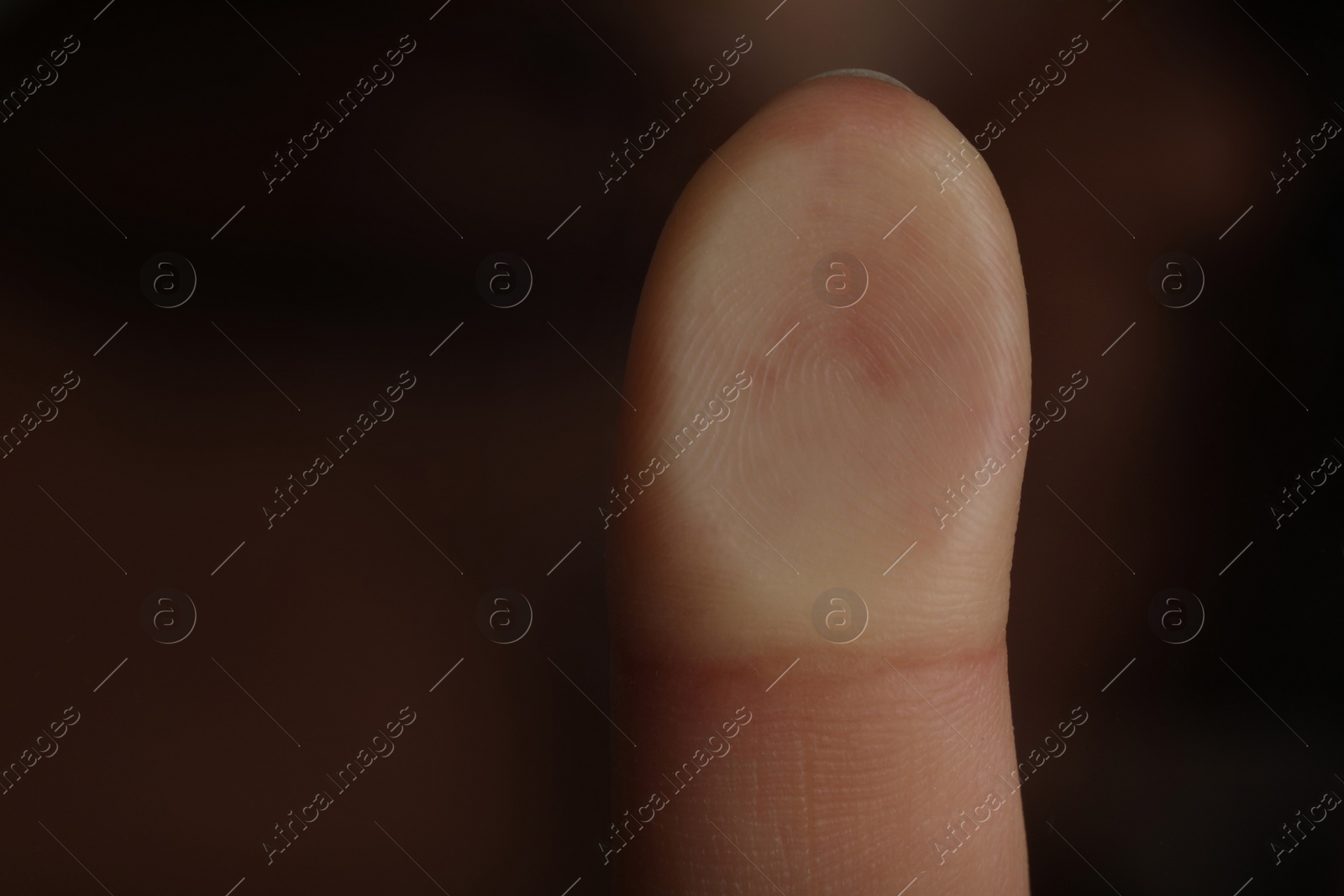 Photo of Woman pressing finger to surface, closeup view. Scanning fingerprint