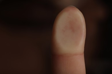 Photo of Woman pressing finger to surface, closeup view. Scanning fingerprint