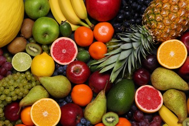 Photo of Different ripe fruits and berries as background, top view