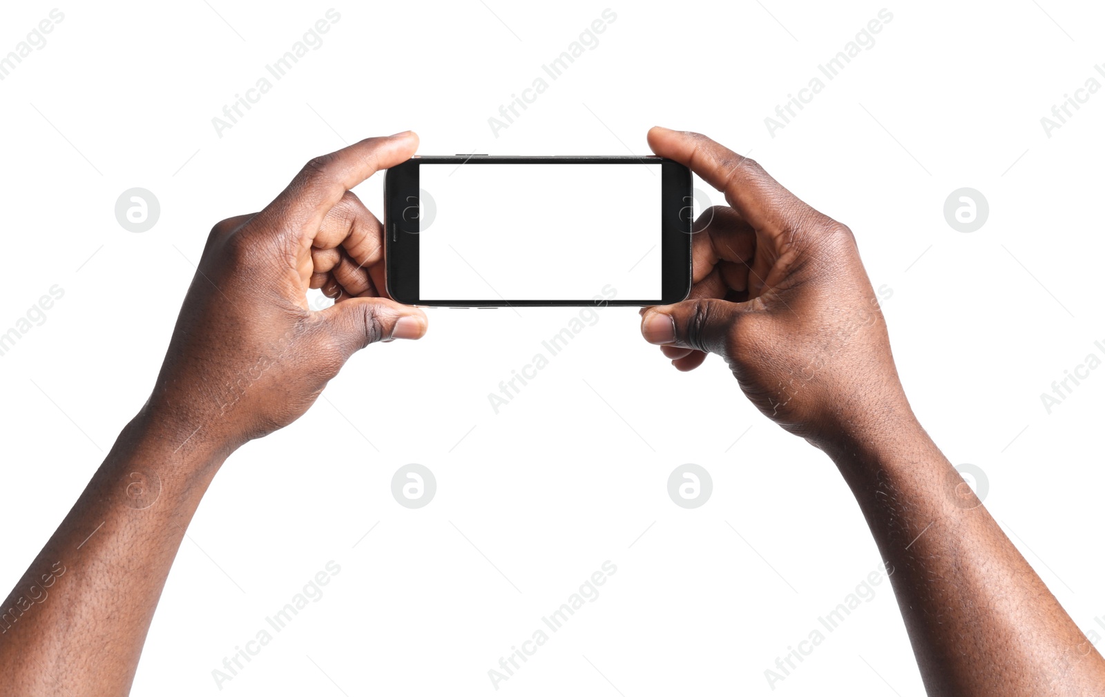 Photo of African-American man holding mobile phone with blank screen in hands on white background