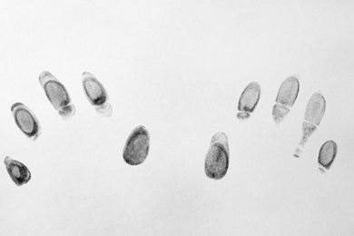 Photo of Black fingerprints on white background, top view