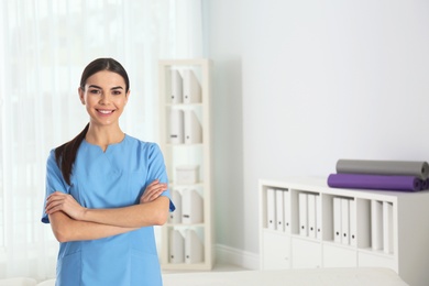 Photo of Portrait of young doctor in hospital, space for text. Rehabilitation physiotherapist