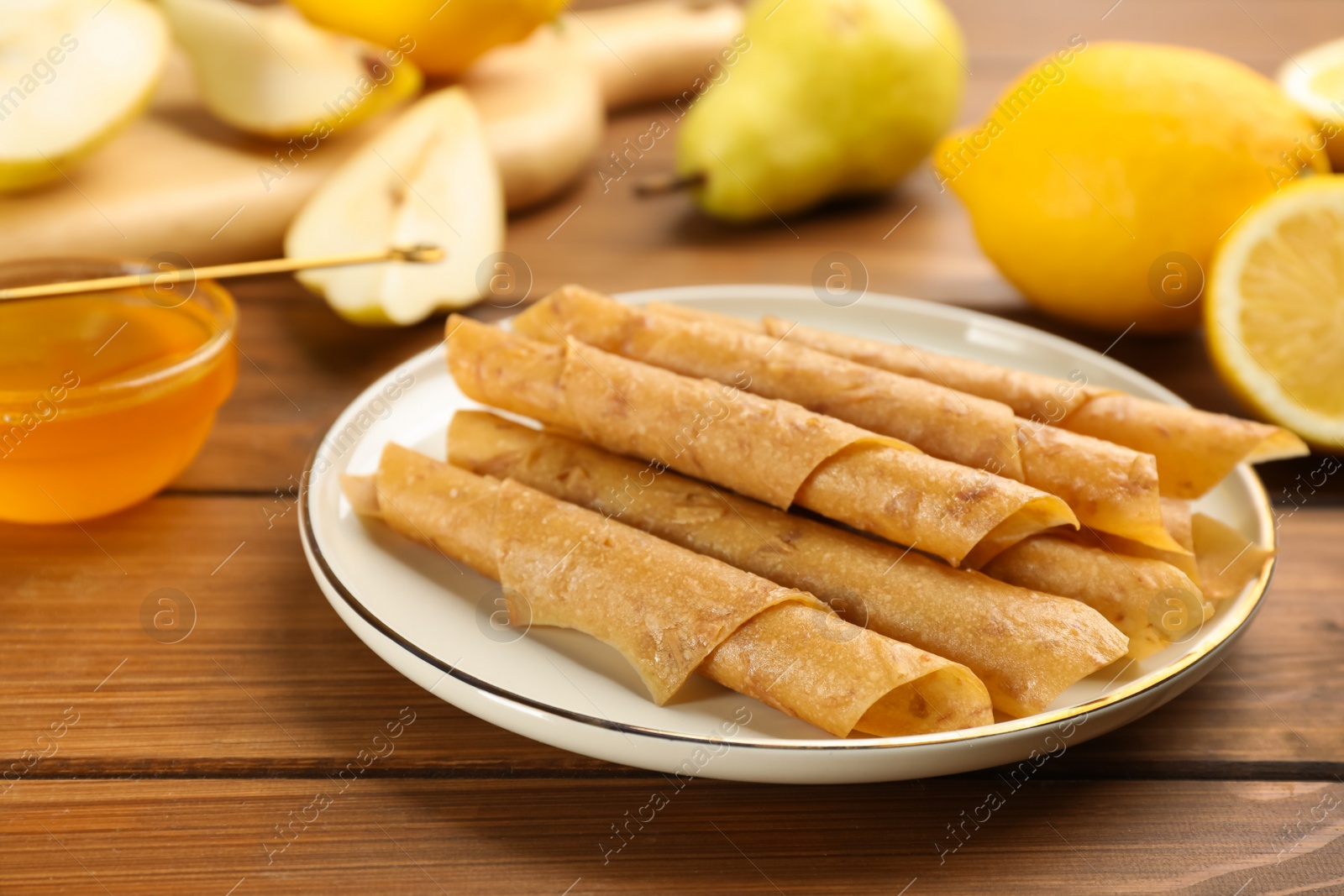 Photo of Composition with delicious fruit leather rolls on wooden table