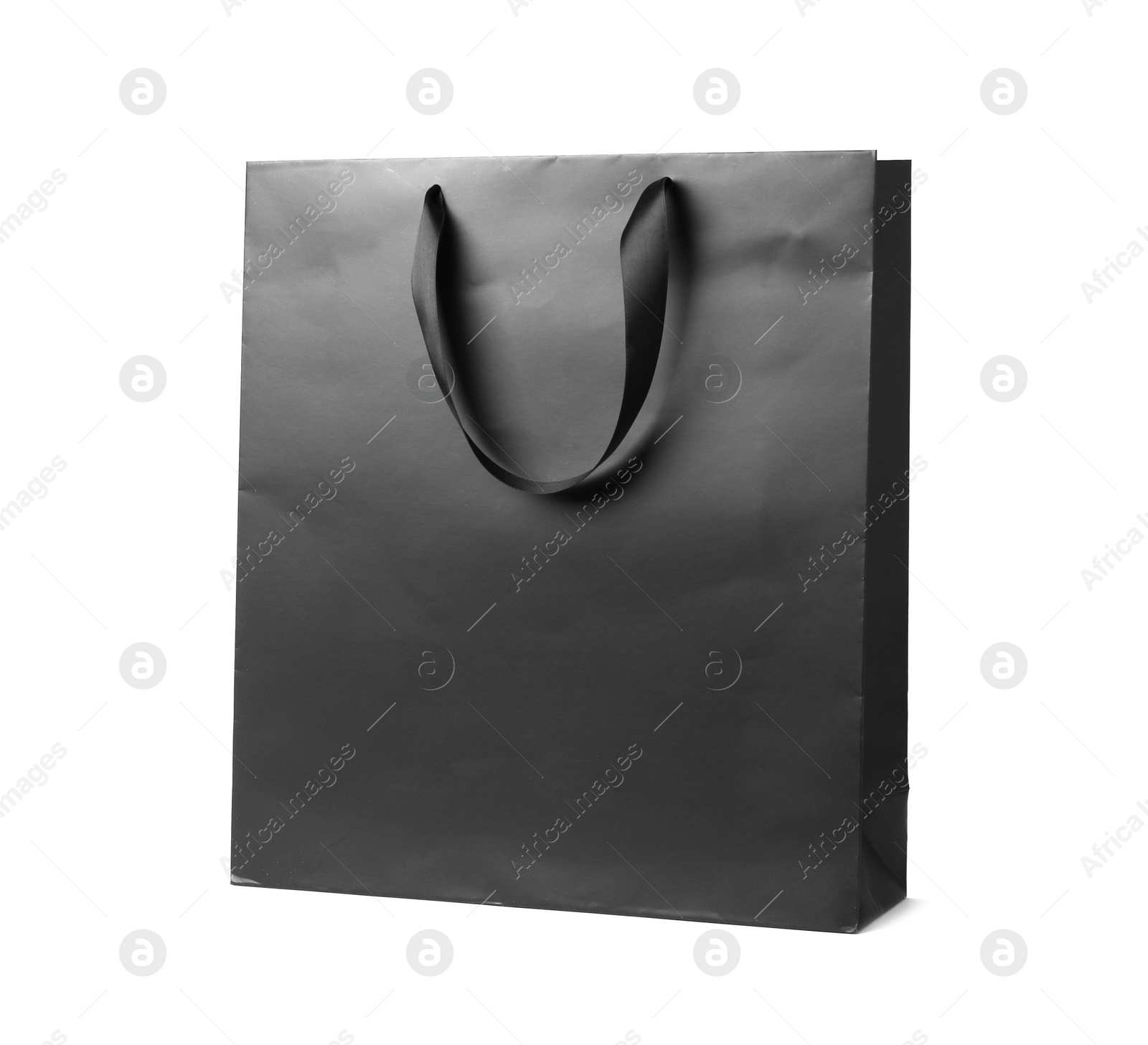 Photo of Paper shopping bag with ribbon handles on white background. Mockup for design