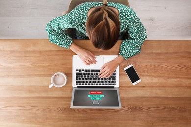 Image of Woman using laptop for online shopping at wooden table, top view