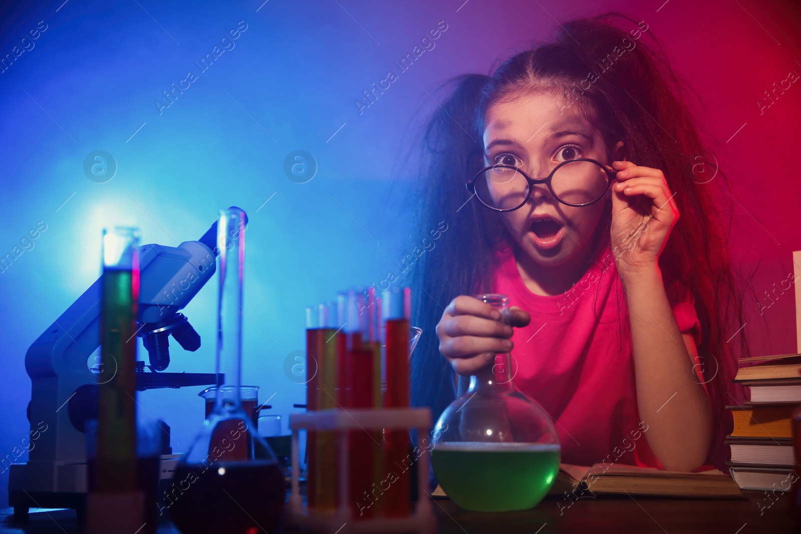 Photo of Child doing chemical research in laboratory. Dangerous experiment