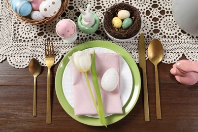 Photo of Festive table setting with beautiful tulip, flat lay. Easter celebration