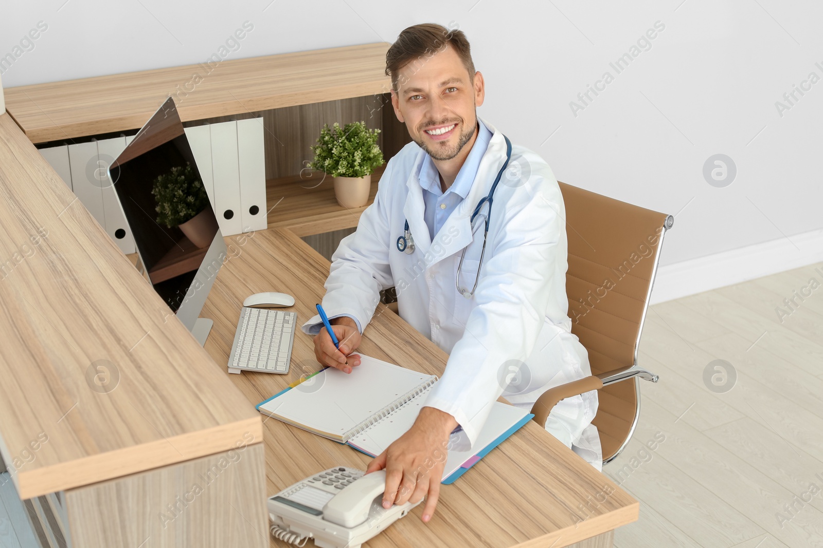 Photo of Male medical assistant at workplace in clinic. Health care service