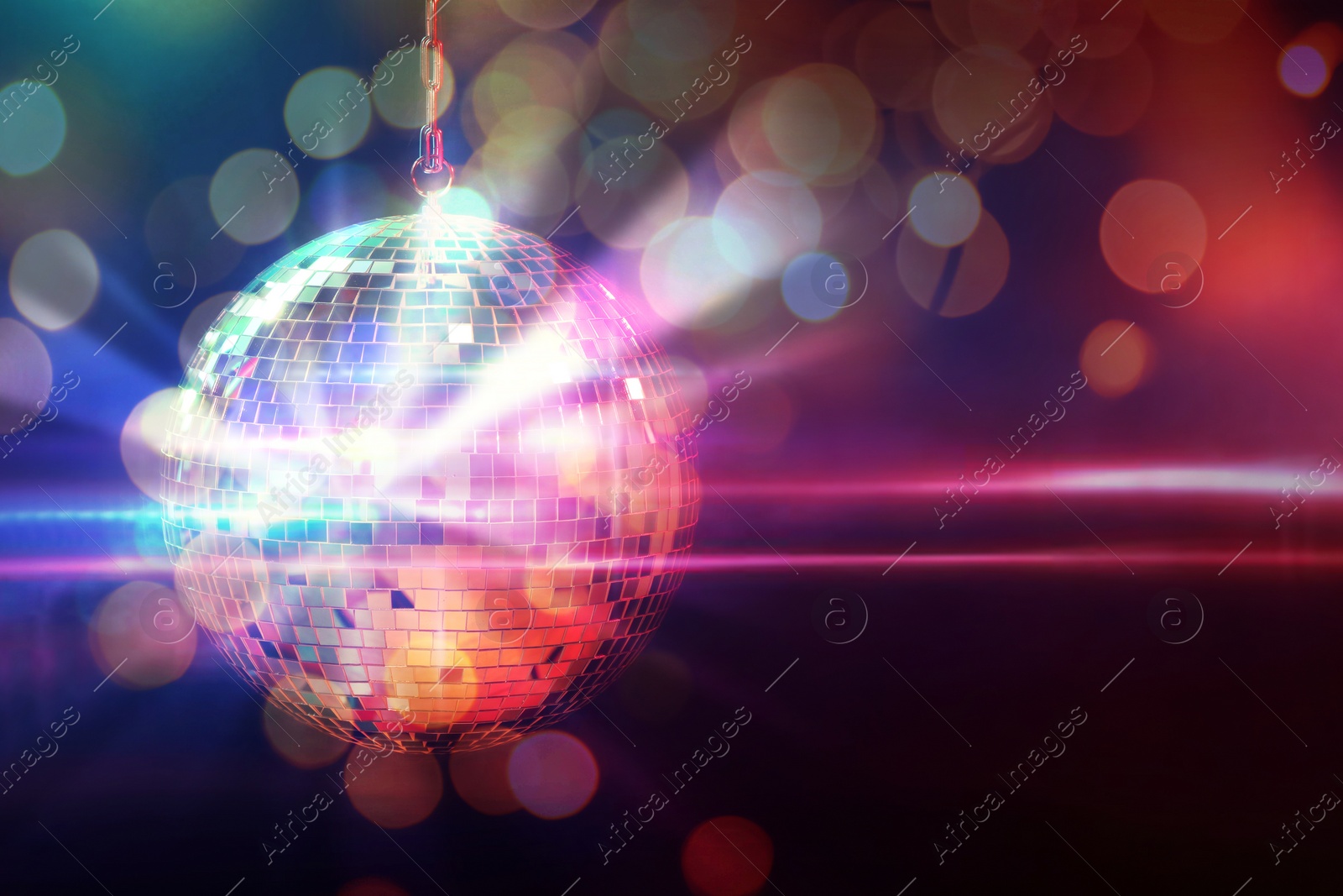 Image of Shiny disco ball on dark background with blurred lights, space for text. Bokeh effect