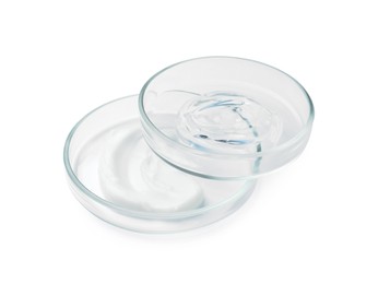 Petri dishes and cosmetic products on white background