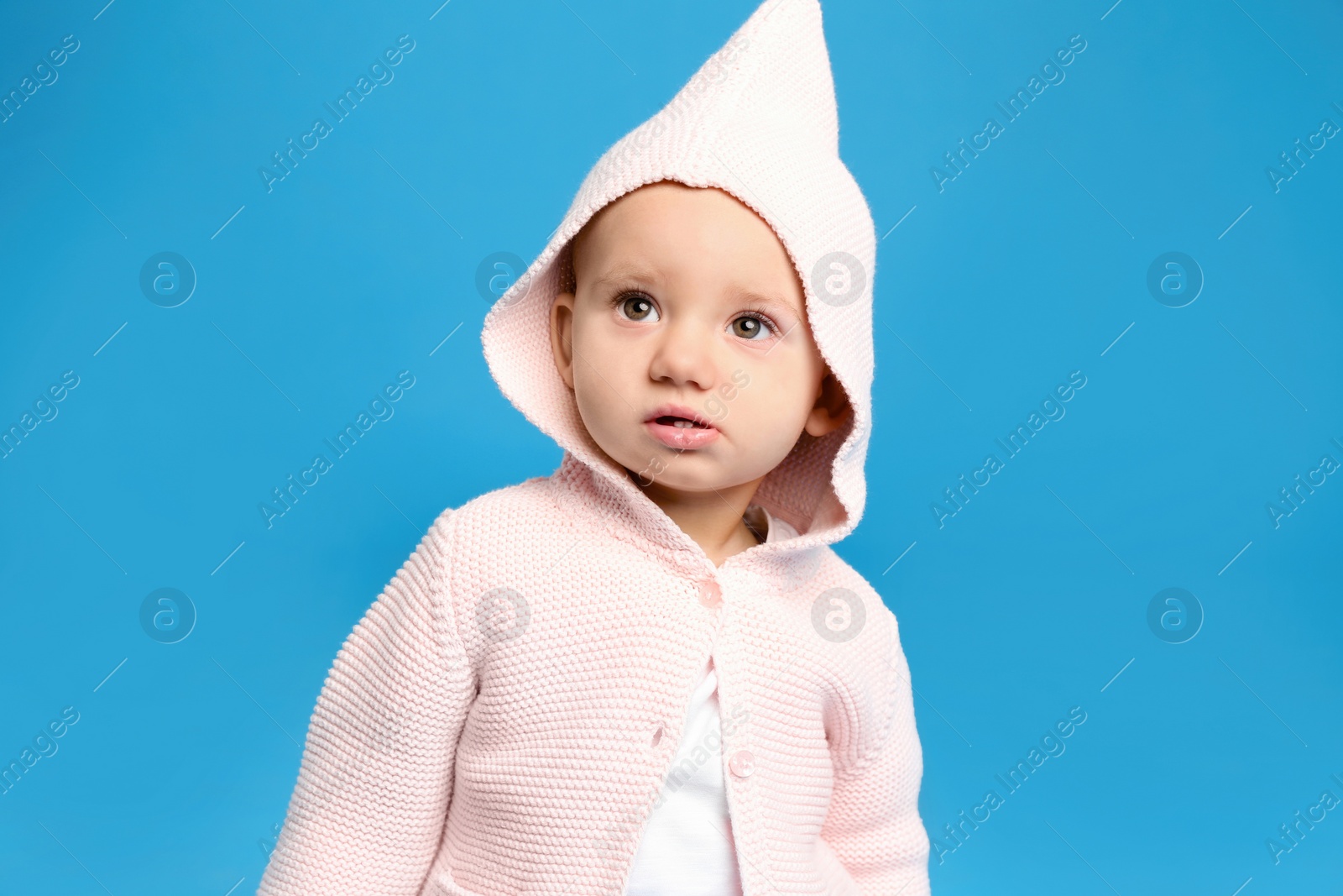 Photo of Cute little child on light blue background