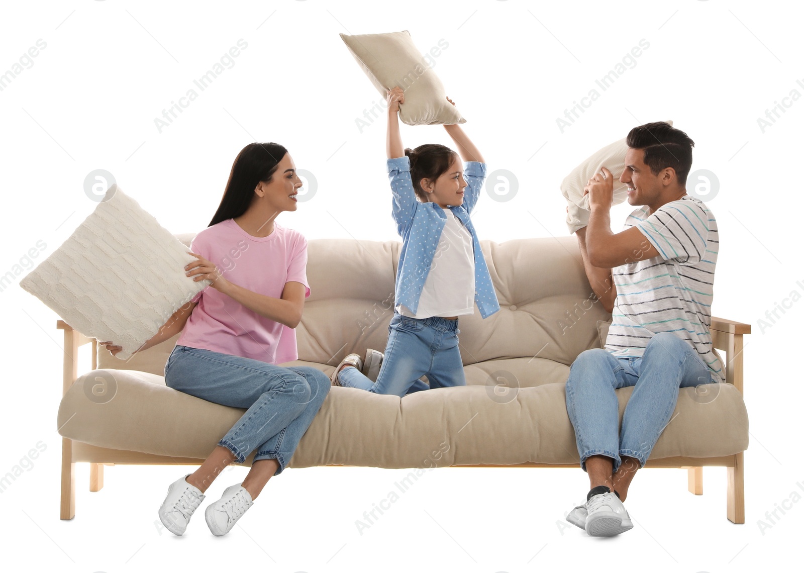 Photo of Happy family having pillow fight on comfortable sofa against white background