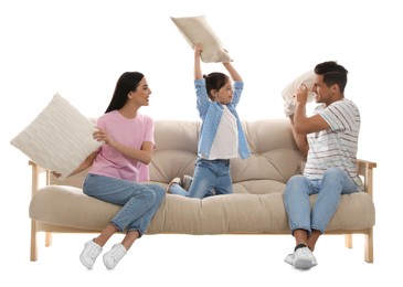 Happy family having pillow fight on comfortable sofa against white background