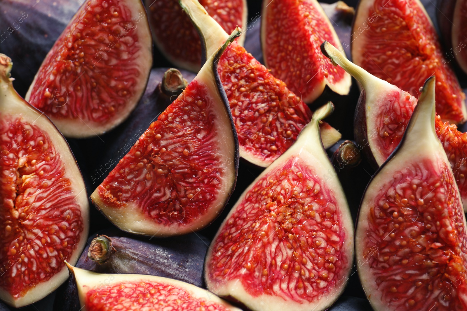 Photo of Fresh ripe fig slices as background. Tropical fruit